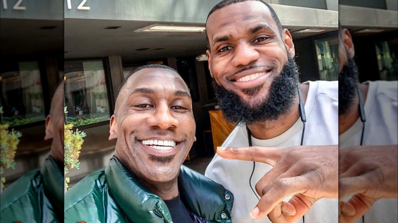 Shannon Sharpe posing for selfie with LeBron James