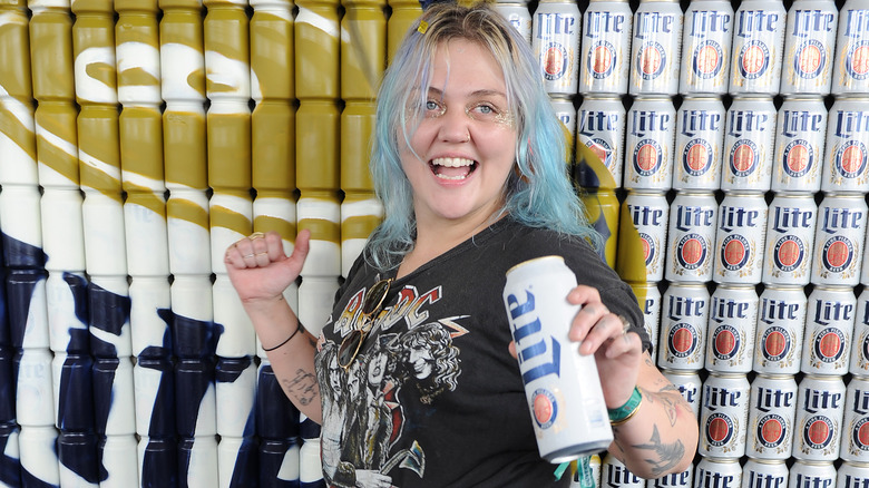 Elle King holds a can of beer