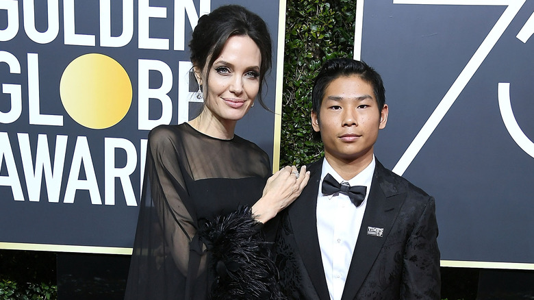 Angelina Jolie posing with Pax-Jolie Pitt