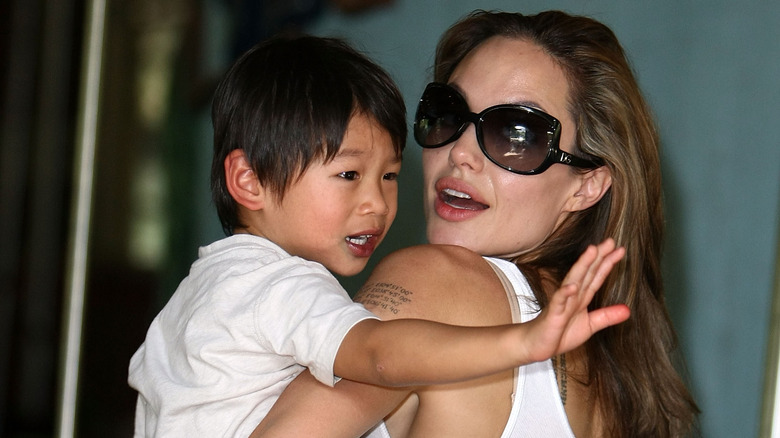 Angelina Jolie carrying Pax Jolie-Pitt