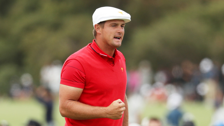 Bryson DeChambeau visible muscle in a red shirt