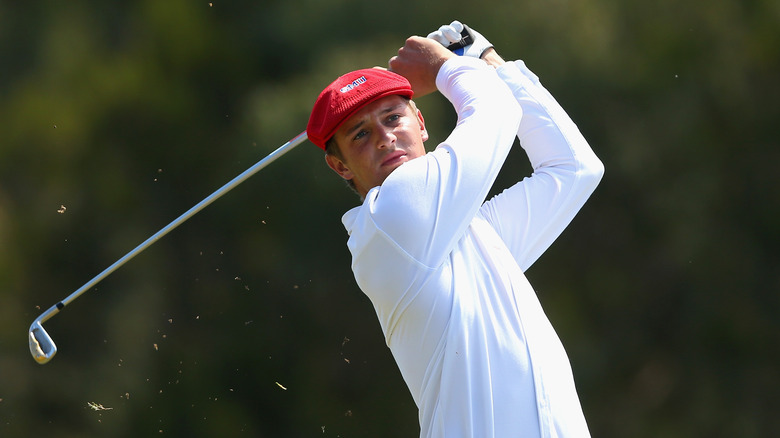 Golf strike in a long sleeved white shirt