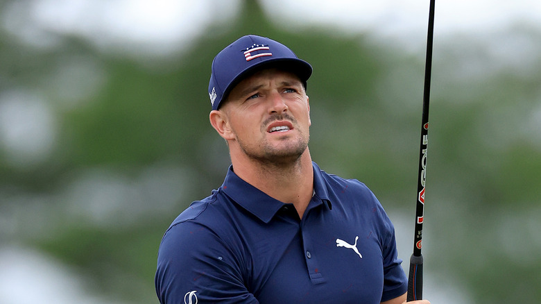 Bryson DeChambeau in navy blue shirt and cap