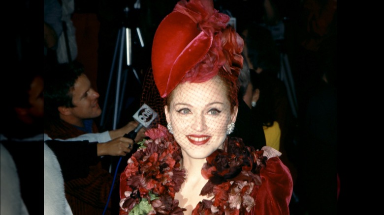 Madonna smiling wearing red hat