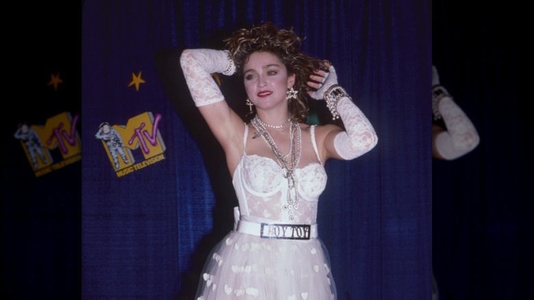 Madonna posing with her hands in hair 