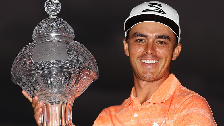 Rickie Fowler smiling with trophy