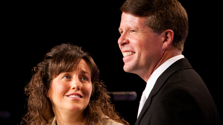 Michelle Duggar staring at Jim Bob Duggar smiling