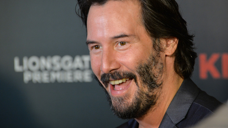 Keanu Reeves grinning big