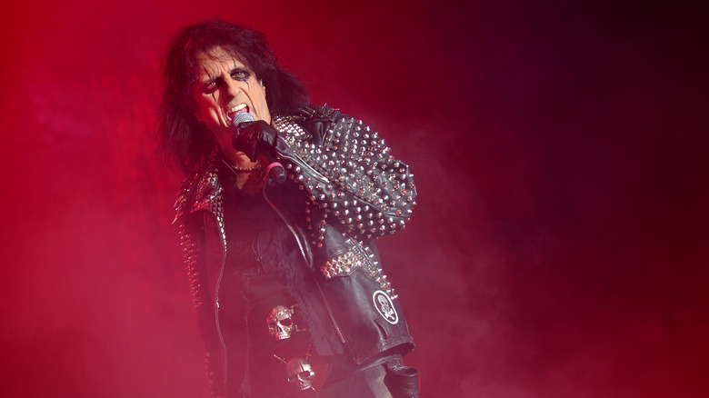 Alice Cooper singing into microphone