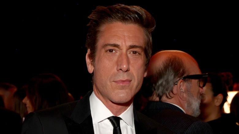 David Muir posing at an event.