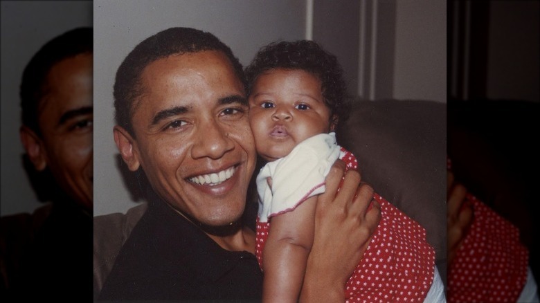 Barack Obama holds baby Sasha
