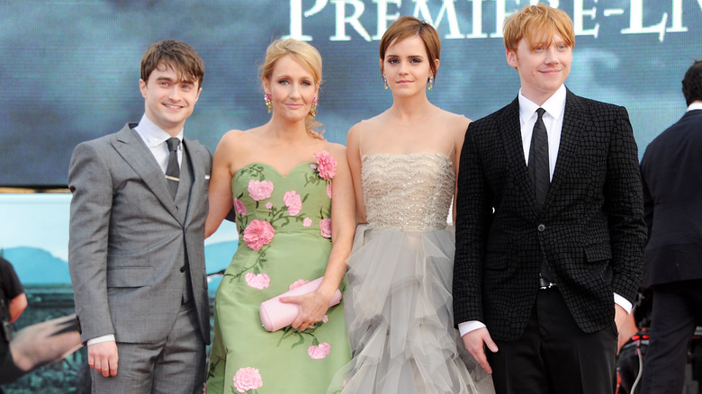 daniel radcliffe, emma watson, jk rowling, and rupert grint on a red carpet