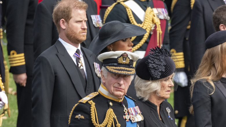 King Charles III with Camilla, Harry, and Meghan