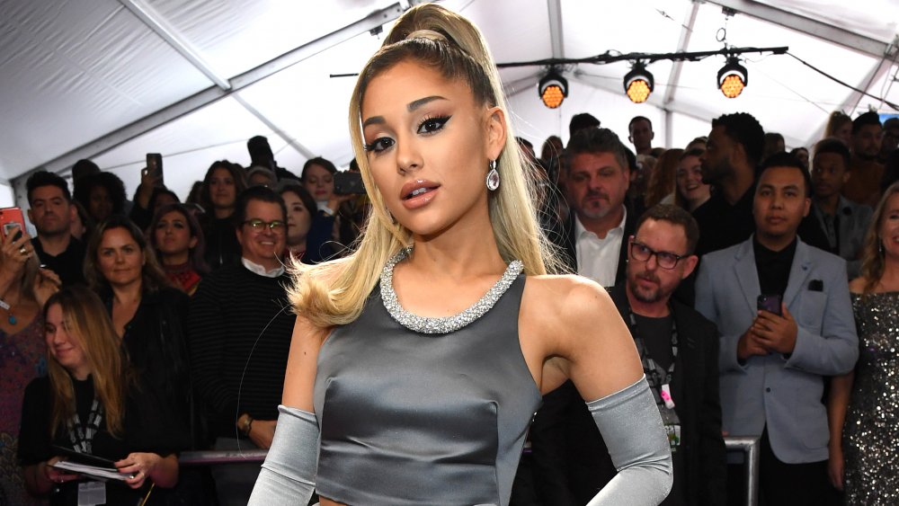 Ariana Grande surrounded by press at the 2020 Grammy Awards