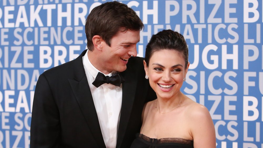 Ashton Kutcher and Mila Kunis laughing on the red carpet