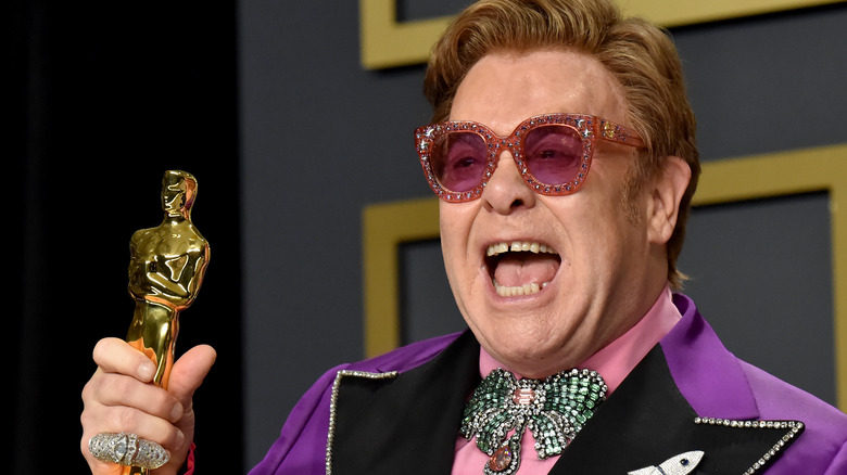 Elton John holding an Oscar