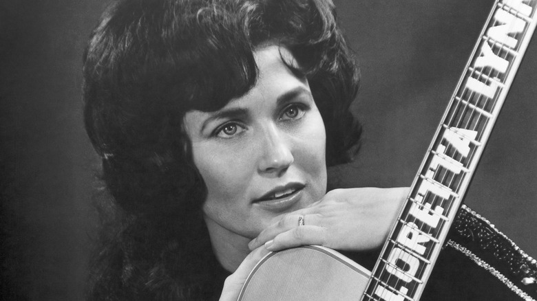 Loretta Lynn posing with guitar