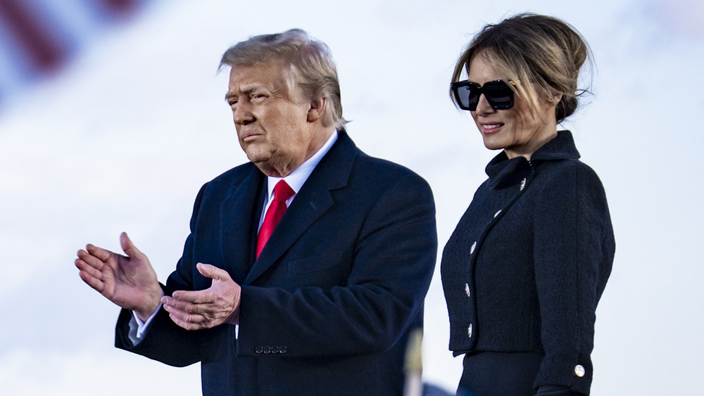 Donald and Melania Trump near American flags