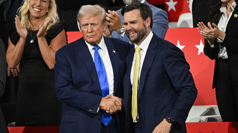 Donald Trump shaking the hand of JD Vance