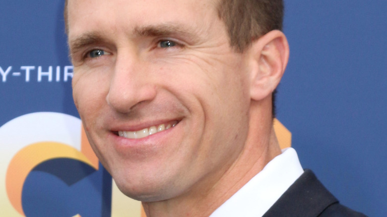 Drew Brees in suit and smiling