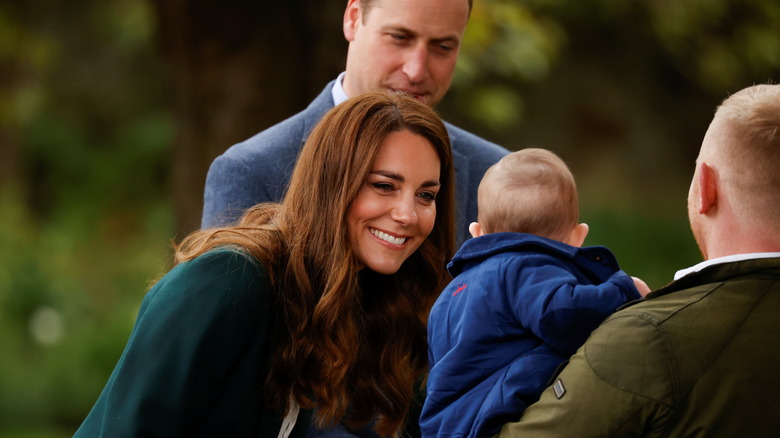 Kate Middleton smiles at a baby