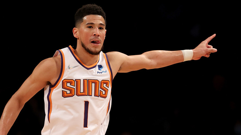 Devin Booker pointing in uniform 