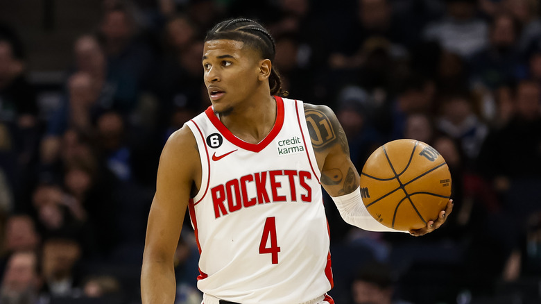 Jalen Green holding a basketball on the court