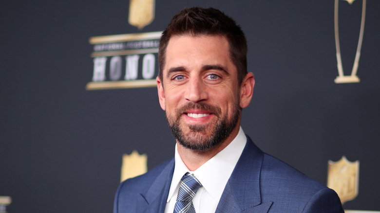 Aaron Rodgers posing at an event