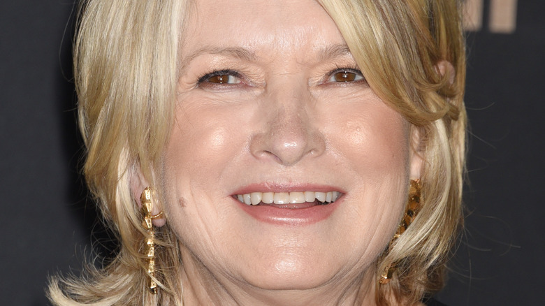 Martha Stewart smiles in gold drop earrings