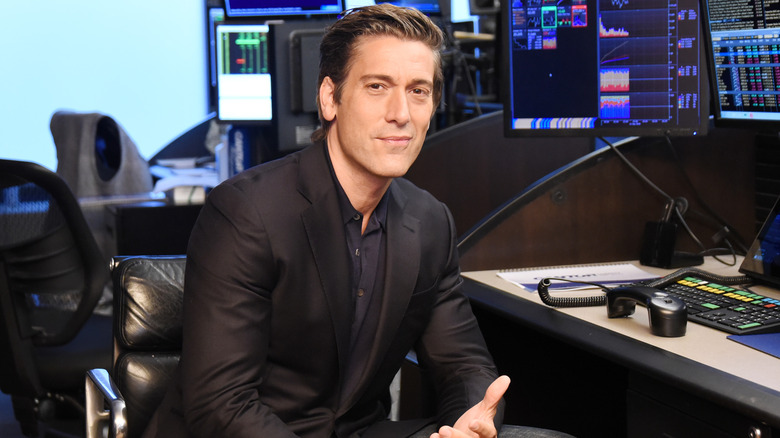 David Muir seated at a computer desk