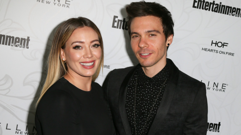 Hilary Duff and Matthew Koma smiling on the red carpet