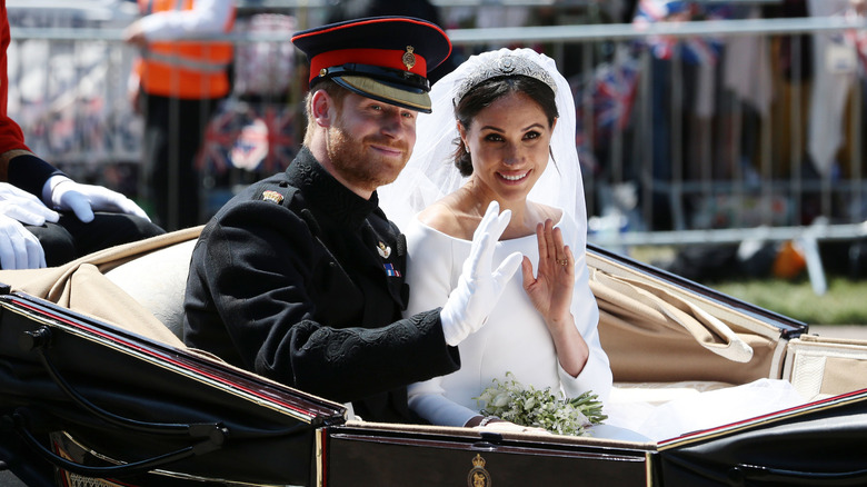 Prince Harry, Duke of Sussex and Meghan, Duchess of Sussex waving from the Ascot Landau Carriage