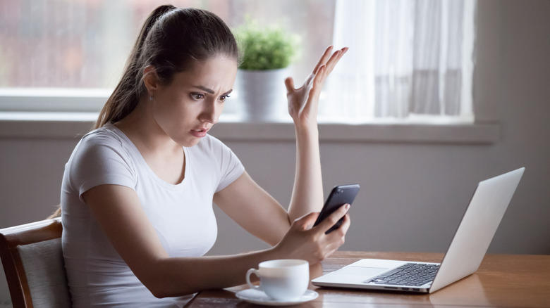 Woman looking confused at phone