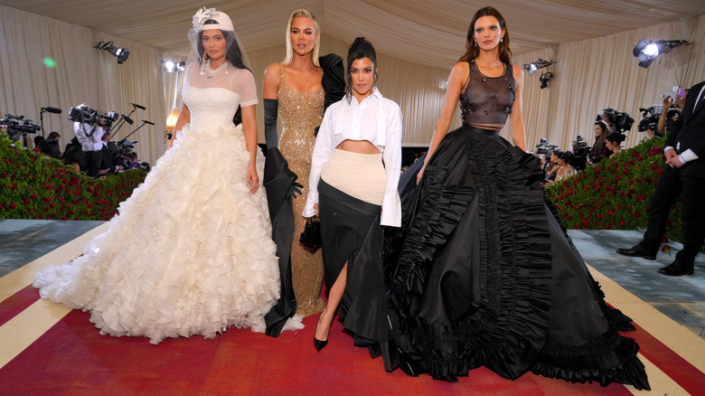 Kylie Jenner, Khloe Kardashian, Kourtney Kardashian, and Kendall Jenner posing at the 2022 Met Gala