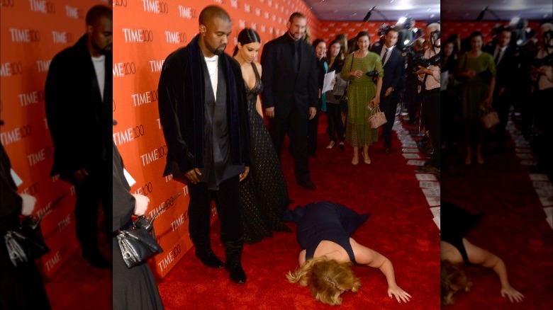 Amy Schumer on the floor in front of Kanye West and Kim Kardashian