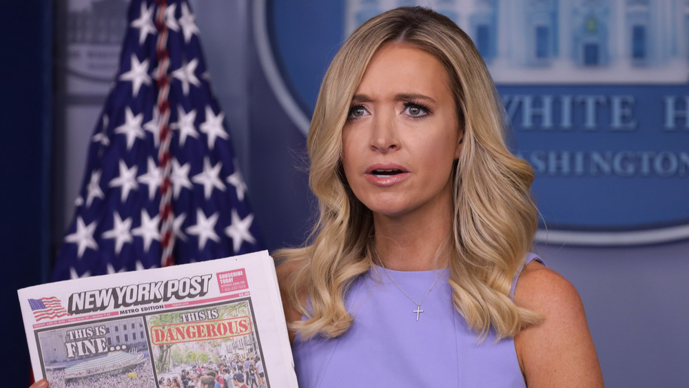 Kayleigh McEnany holding a newspaper