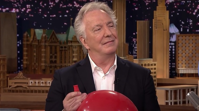 Alan Rickman holding a balloon