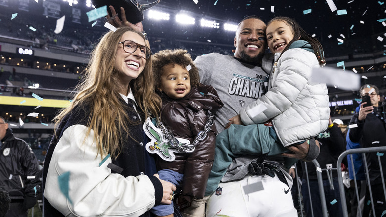 Saquon Barkley #26 of the Philadelphia Eagles celebrating with his family after the game against the Washington Commanders at Lincoln Financial Field