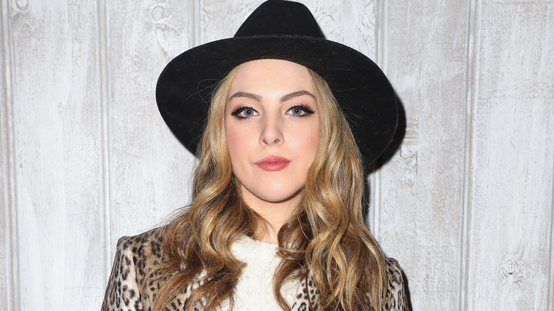 Liz Gillies wearing a black hat