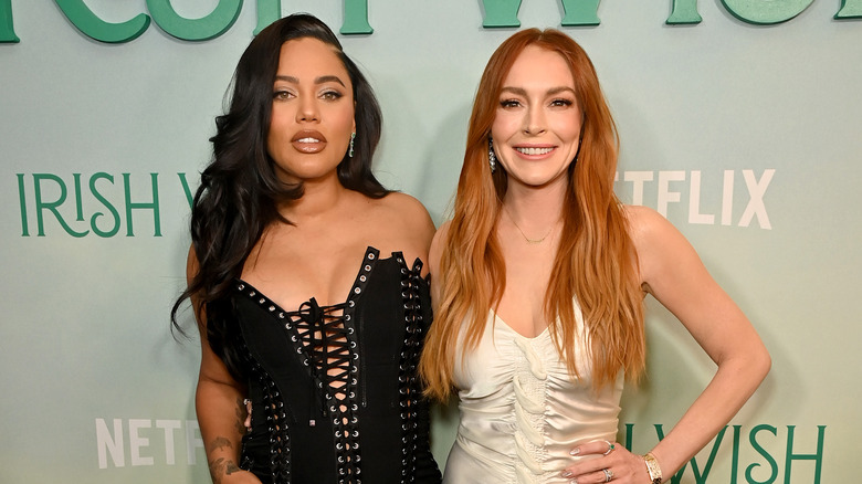 Ayesha Curry and Lindsay Lohan posing at the premiere of Irish Wish