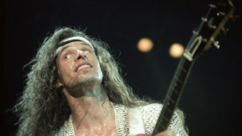 Ted Nugent playing guitar in concert