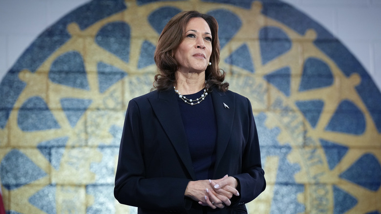 Kamala Harris posing in front of a mural