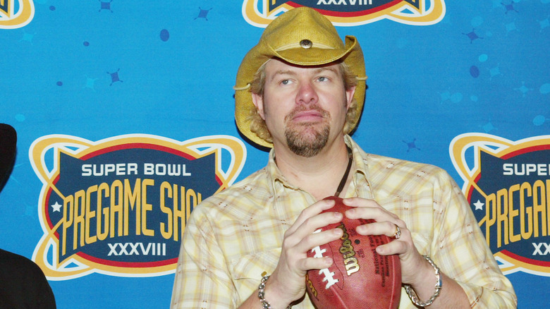 Toby Keith holding a football