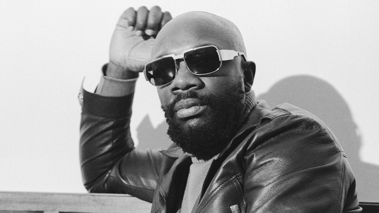 Isaac Hayes sitting wearing sunglasses