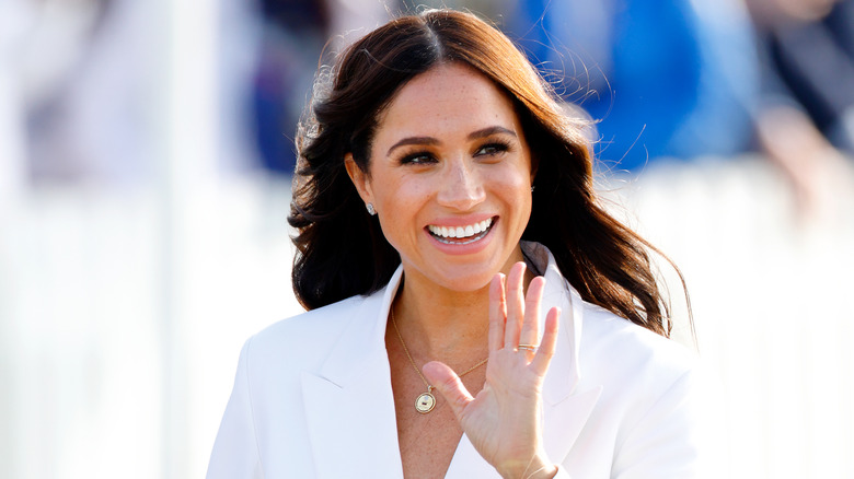 Meghan Markle waves