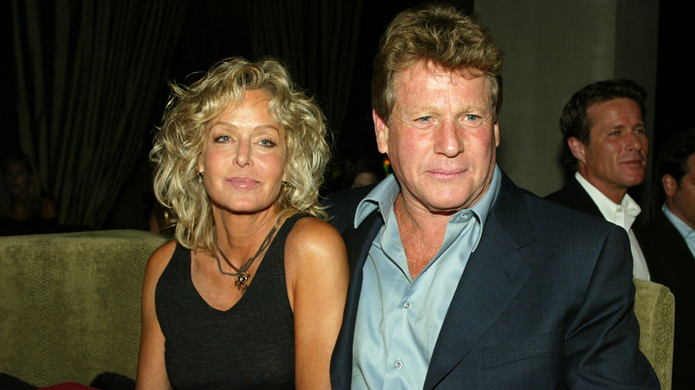 Farrah Fawcett Ryan ONeal sitting at dinner