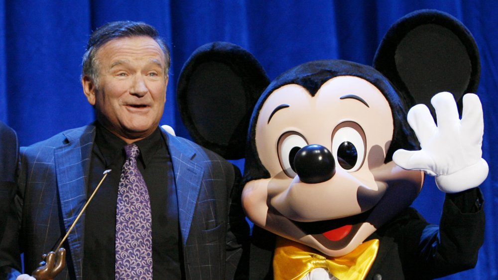 Robin Williams smiles with Mickey Mouse