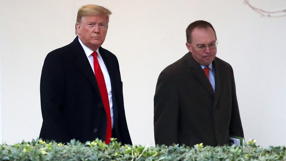 Donald Trump walking with Mick Mulvaney