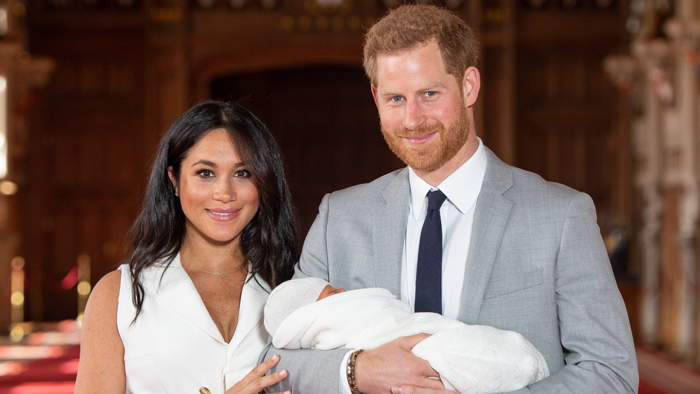 Meghan Markle and Prince Harry holding their son, Archie Harrison