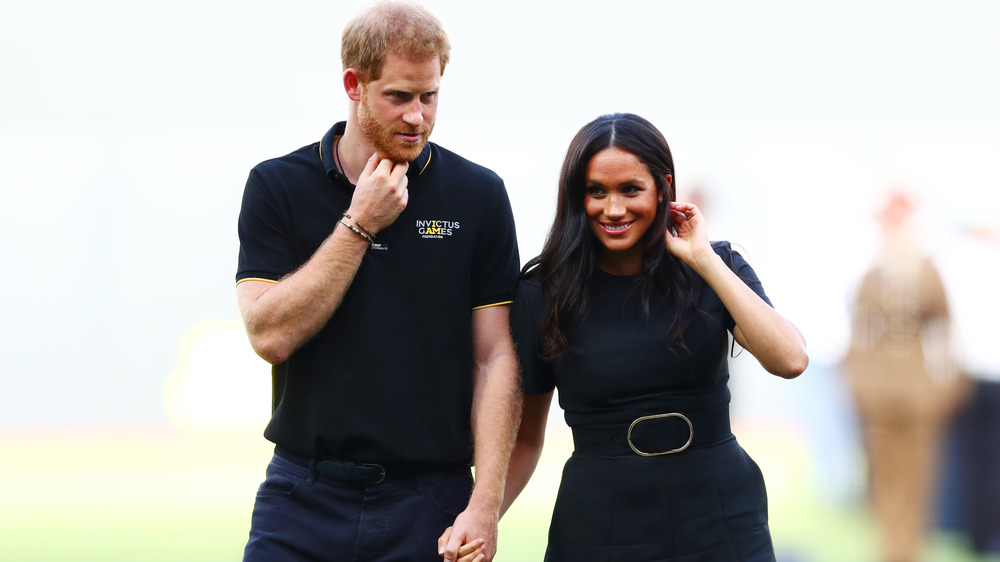 Prince Harry and Meghan Markle holding hands